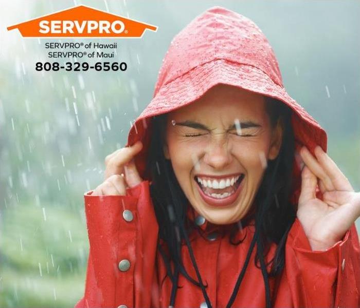 A person is getting drenched during a rainstorm.