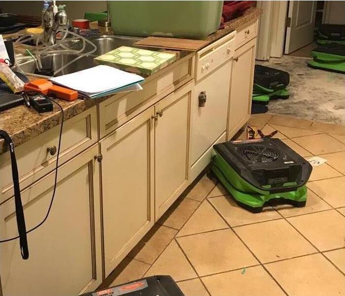 kitchen with massive water damage and dryer set in place