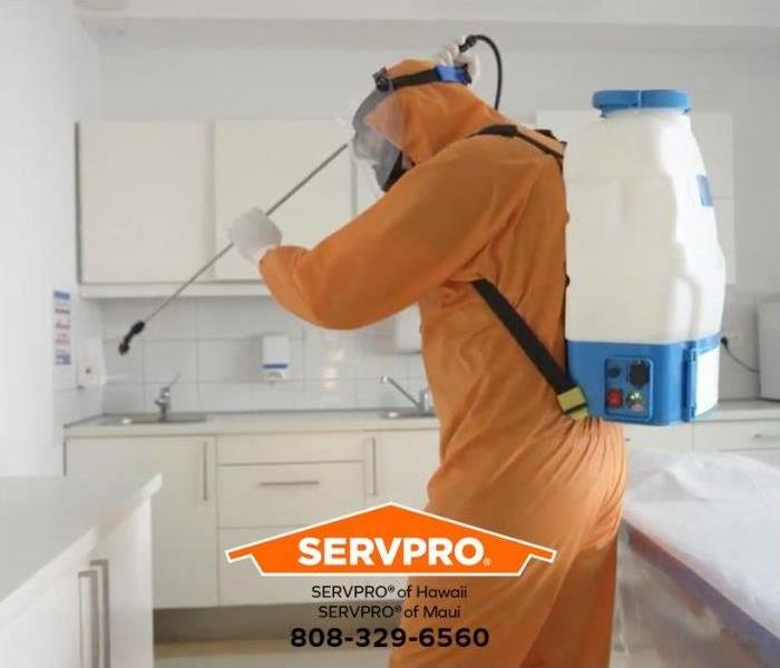 A technician is sanitizing a room.