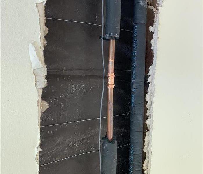 was with a drywall hole cut out with copper water line inside with a coupling